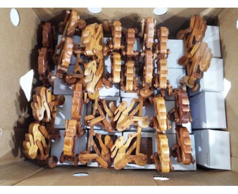 A good lot of 36 wooden toys to include twenty secret compartment trinket boxes depicting the moon, boxed and sixteen push-al