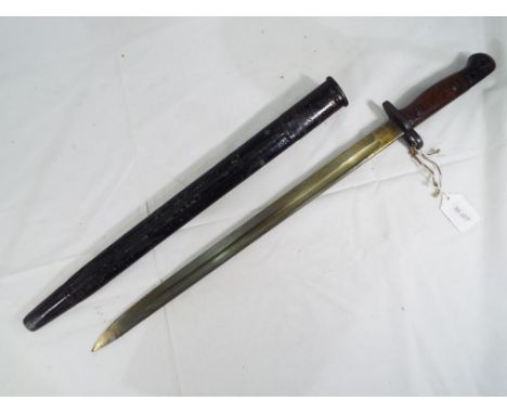 A British 1907 Pattern Bayonet, and Scabbard. The blade is stamped with a crown over "G.R. 1907 and the makers name "Wilkinso