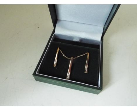 A lady's 9 carat gold 20 point diamond stick pendant and earrings set, approx 2.1 gm (all in), unused surplus retail stock (N