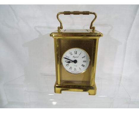 A contemporary French eight day carriage clock with mechanical movement, inscribed Bayard with gilt mask around a circular en