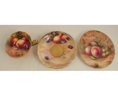 A Royal Worcester trio, the interior of the cup painted with fruit to a mossy background by Townsend, the saucer painted with