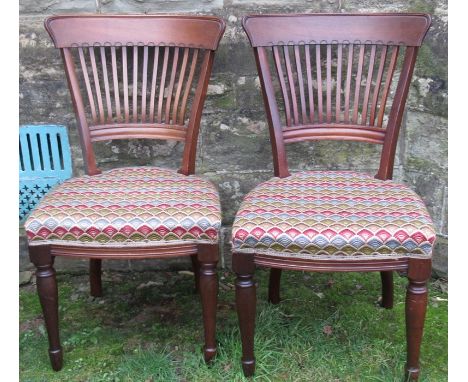 A pair of mahogany chairs, with tapestry seats, together with a pair of oak open arm dining chairs