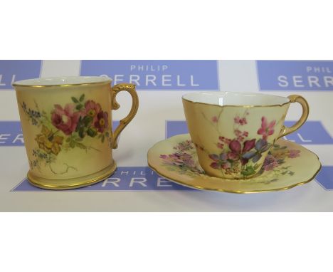 A Royal Worcester blush ivory tea cup and saucer, decorated with flowers, dated 1905, together with a Royal Worcester blush i