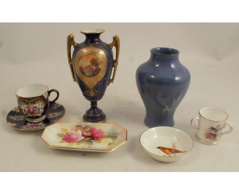 A Royal Worcester 18th century style coffee cup and saucer, decorated with panels of flowers to a scale blue, together with a