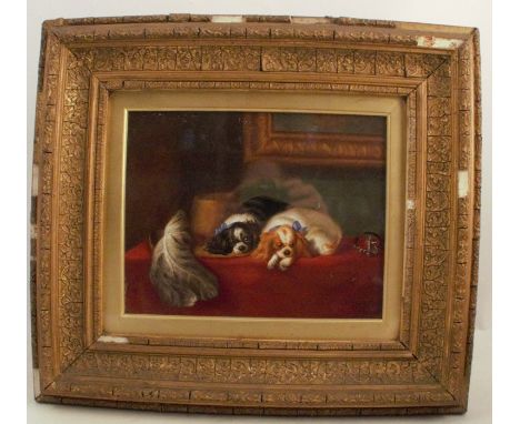 A 19th century rectangular porcelain plaque, decorated with Cavalier King Charles spaniels on a table by a feather hat, 7.5in