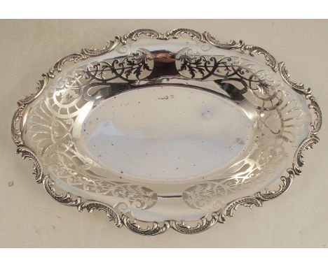 An oval silver pierced dish, with scroll edge, Sheffield 1900, maker William Hutton &amp; Sons Ltd, weight 9oz, diameter 11.5