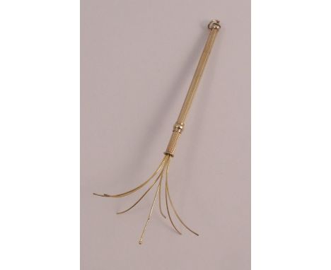 A swizzle stick, stamped '9ct', with engine turned decoration, 4.2g gross