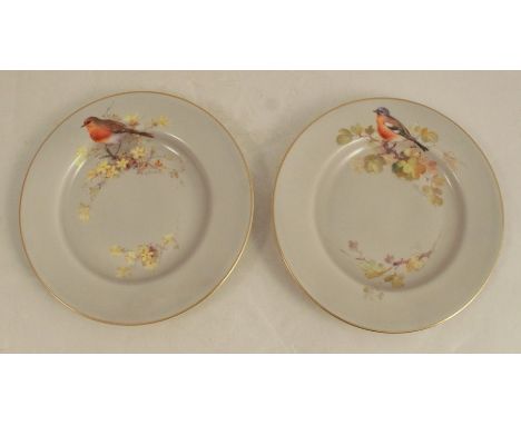 A pair of Royal Worcester side plates, decorated with a bull finch and a robin by William Powell, circa 1925, diameter 6insCo