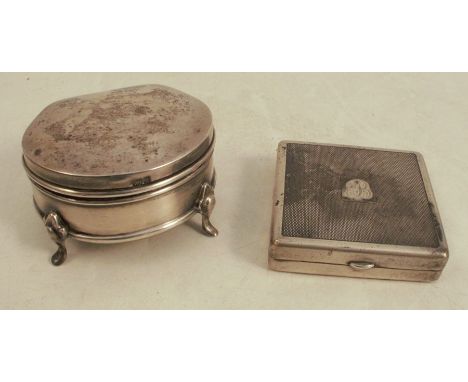 A silver ring box, raised on four scroll legs, Birmingham 1905, together with a ladies silver compact of square form with eng