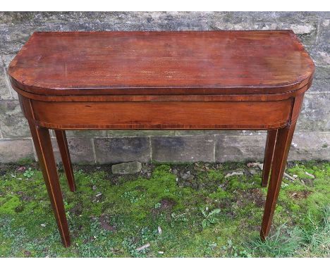 A Georgian mahogany fold over card table, with D shaped cross banded top and raised on four square tapering legs, possibly cu