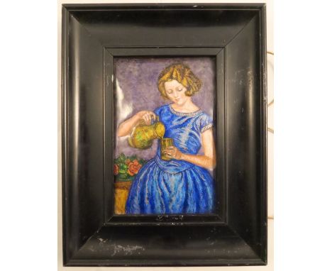 A rectangular enamel plaque, of a girl in a blue dress pouring water from a pitcher, inscribed to the reverse, E M Wilesmith,