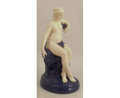 A Royal Worcester figure of a naked girl, seated on a Sabrina blue naturalistic outcrop, height 8insCondition Report:  Crazed