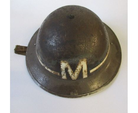 A WW2 black metal messenger's helmet, with a painted white band and "M" to one end