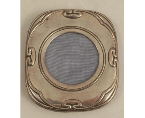 A hallmarked silver mounted photograph frame, embossed with Art Nouveau motifs, with wooden back and easel support, overall h