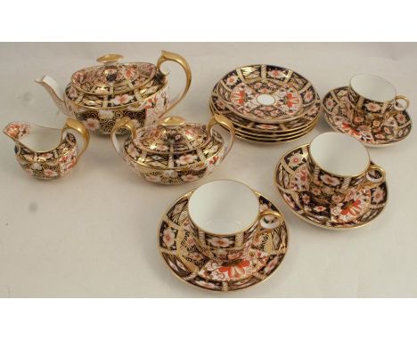 A collection of Royal Crown Derby Imari pattern china, consisting of a tea pot af, covered sugar bowl, milk jug af, three cup