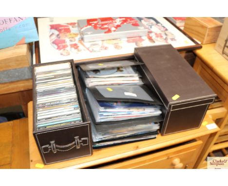 Two faux leather CD storage boxes and a quantity of various DVDs