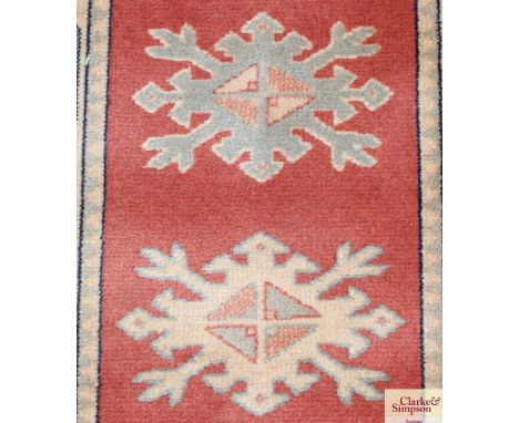 An approx. 8'10" x 2'3" orange floral patterned runner