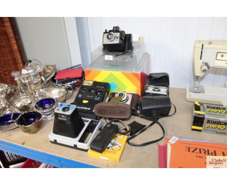 A quantity of various cameras to include Polaroid, Ilford and Kodak