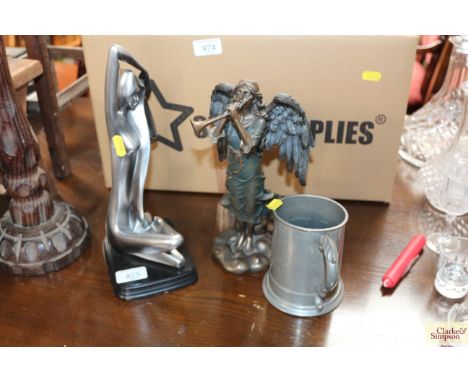 An ornament in the form of an angel together with a pewter tankard, a travel clock and a modern figure