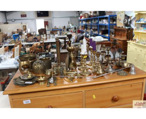 A quantity of various brassware to include candlesticks, door knocker in the form of a fox, Madonna and child etc