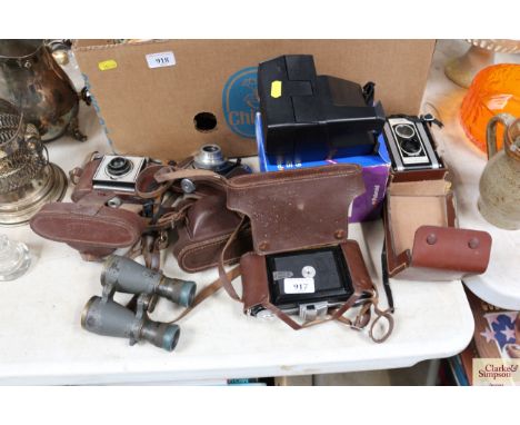 A quantity of various cameras to include Kodak and a pair of vintage binoculars