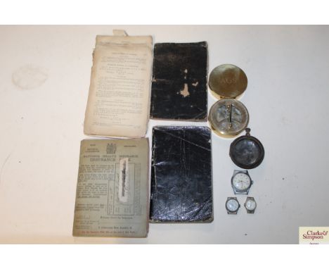 A reproduction brass compass, three wristwatches, a pocket watch case and various ephemera