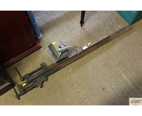 Two sash clamps and a small vice
