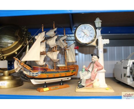 A decorative clock together with a model of HMS Bounty