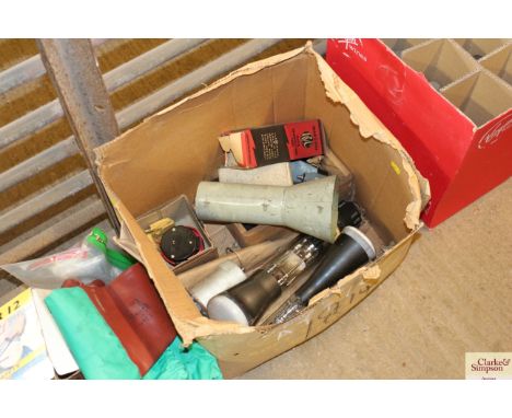 A cardboard box of vintage light bulbs and other various electrical items