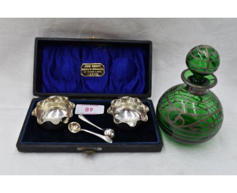 A cased pair of Victorian silver salts having frilled rims and matched white metal spoons, Birmingham 1899, maker M &amp; A, 