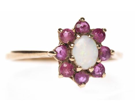 RUBY AND OPAL FLORAL CLUSTER RINGset with a central oval cabochon cut opal surrounded by round rubies, in nine carat yellow g