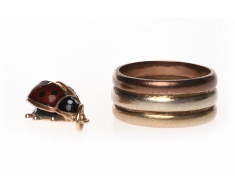 NINE CARAT GOLD RING AND LADYBIRD CHARMthe tricolour ring formed by a solid band of three colours, stamped 9ct to the inside,