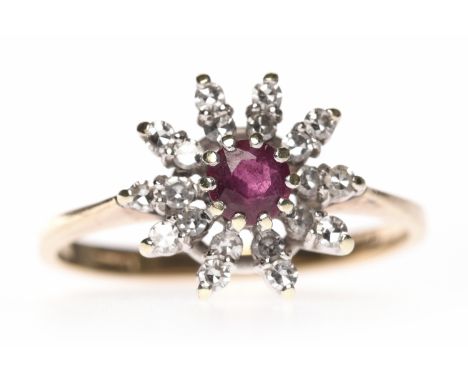 NINE CARAT GOLD RUBY AND DIAMOND CLUSTER RINGset with a central round ruby surrounded by radiating diamond set sections, size