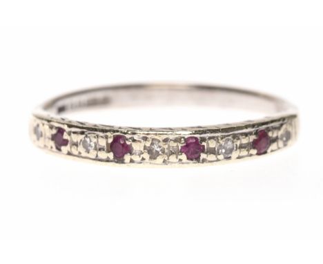 NINE CARAT WHITE GOLD DIAMOND AND RUBY HALF ETERNITY RINGset with alternating diamonds and rubies, with engraved edges, size 