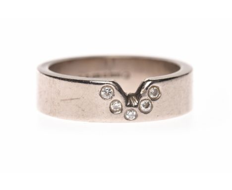 EIGHTEEN CARAT WHITE GOLD SHAPED DIAMOND SET WEDDING BANDwith a V shaped notch and with five countersunk round diamonds, size