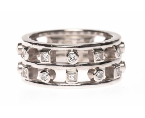 EIGHTEEN CARAT WHITE GOLD DIAMOND SET BANDformed by two rows of collet set round brilliant cut diamonds alternating with coll