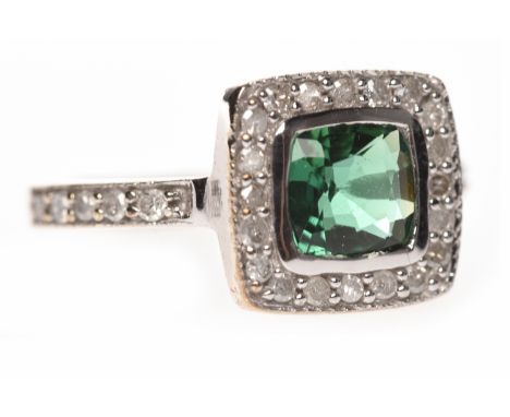 NINE CARAT WHITE GOLD GEM AND DIAMOND DRESS RINGset with a central cushion shaped green gem 5.5mm across and in a collet sett