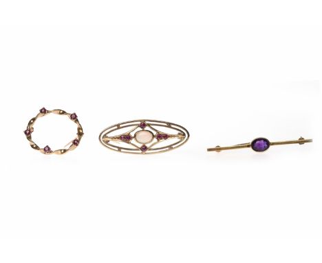 THREE VARIOUS BROOCHEScomprising an amethyst bar brooch in nine carat gold, 1.4g; an oval ruby brooch in nine carat gold, 2.2