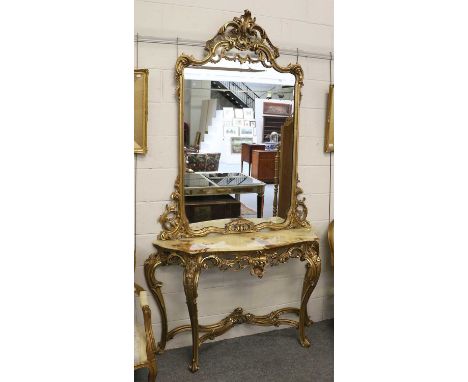 A Giltwood Marble-Topped Serpentine Console Table with Wall Mirror, both of elaborate foliate scroll design, the table on fou