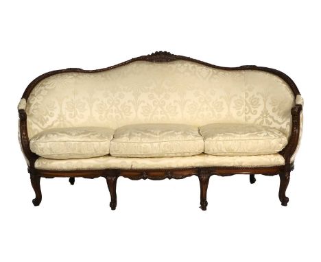 A Late 19th Century Carved Walnut or Beech Three-Seater Sofa, covered in yellow silk damask, the carved frame with padded bac
