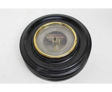 Aneroid wall barometer in ebonised wood case, the silvered dial with black lettering, 24cm diameter