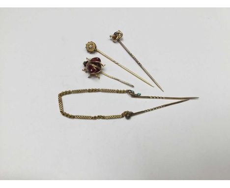 Group of four gold stick pins to include a novelty 9ct gold and enamel flying ladybird stickpin, and three Victorian gold sti