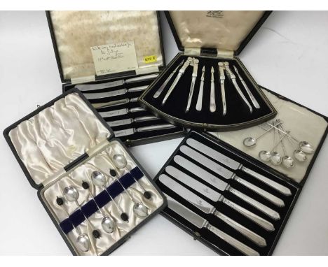 Two set of six silver coffee spoons, two set of six silver handled tea knives in fitted case and a nut cracker set in case