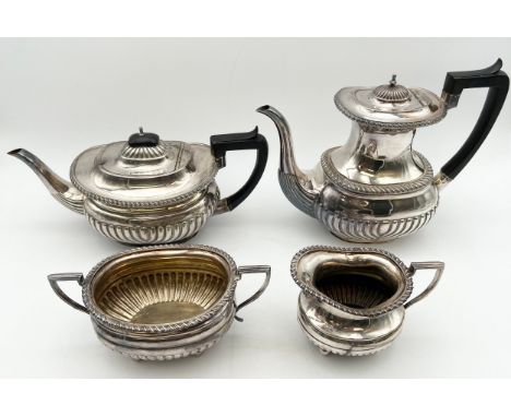 A matched silver plated tea and coffee service to include a twin handled sugar pot and a creamer by Elkington, and a teapot a