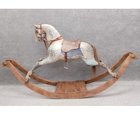 A C.1900 F.H. Ayres plane carved rocking horse painted in white with dappled areas of grey, with a leather saddle and reigns 