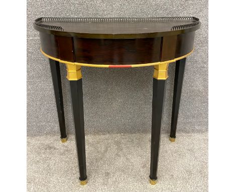 An Empire style demi lune console table by Decca, with a pierced metal tray top surround, on hexagonal tapering ebonised and 