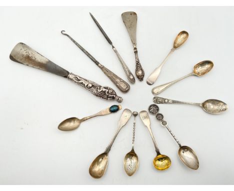 A collection of silver hallmarked items to include four spoons, a shoehorn, a letter opener, and a hook, along with some othe