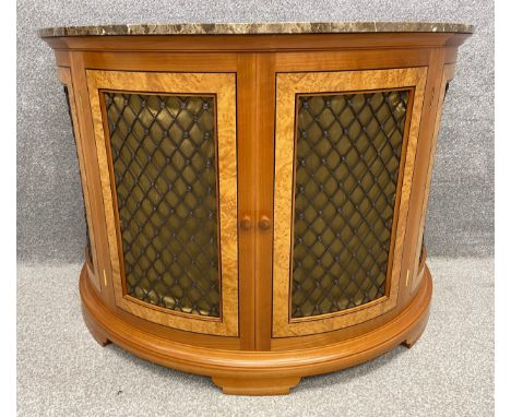 A contemporary walnut and birdseye maple demi-lune console table or radiator cabinet with metal latticework doors and a marbl