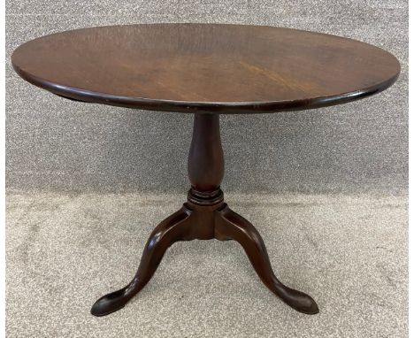 A Georgian Cuban mahogany tripod table on pad feet with a tilt top action. H.73 Dia.90cm