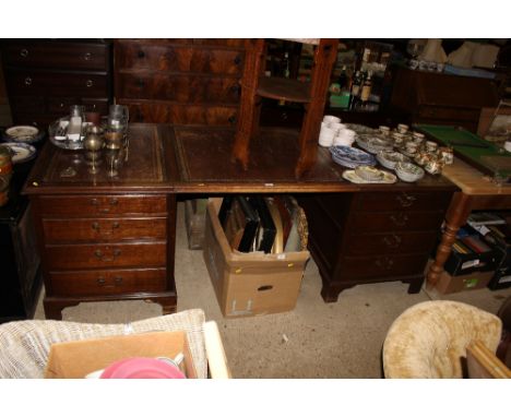 A large oak pedestal writing desk fitted eight drawers 